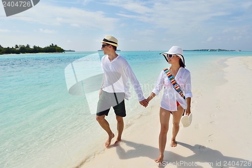 Image of happy young couple have fun on beach
