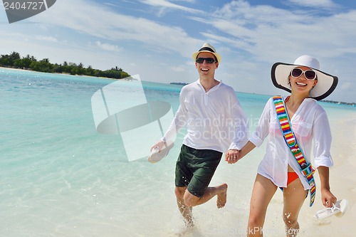 Image of happy young couple have fun on beach