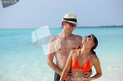 Image of happy young couple have fun on beach