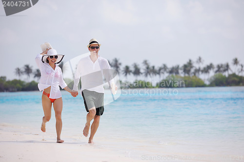 Image of happy young couple have fun on beach