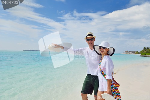 Image of happy young couple have fun on beach