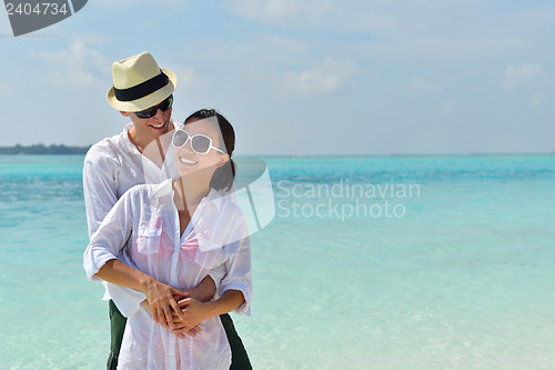 Image of happy young couple have fun on beach