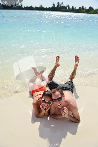 Image of happy young couple have fun on beach