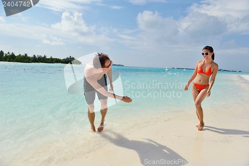 Image of happy young couple have fun on beach