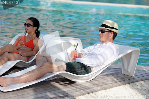 Image of happy young couple relax and take fresh drink