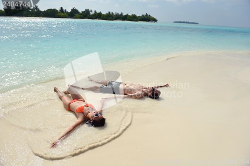 Image of happy young couple have fun on beach