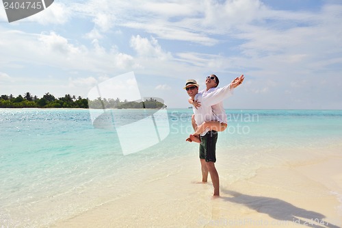 Image of happy young couple have fun on beach