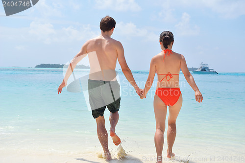 Image of happy young couple have fun on beach
