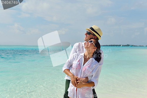 Image of happy young couple have fun on beach