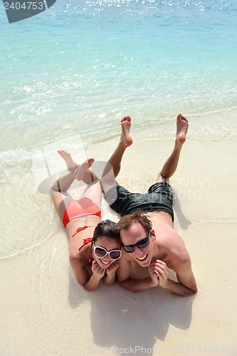 Image of happy young couple have fun on beach