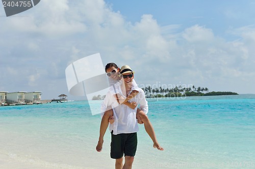 Image of happy young couple have fun on beach