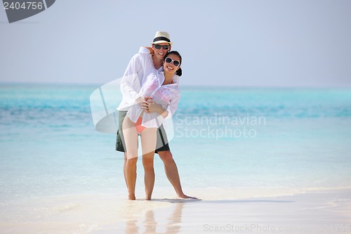 Image of happy young couple have fun on beach