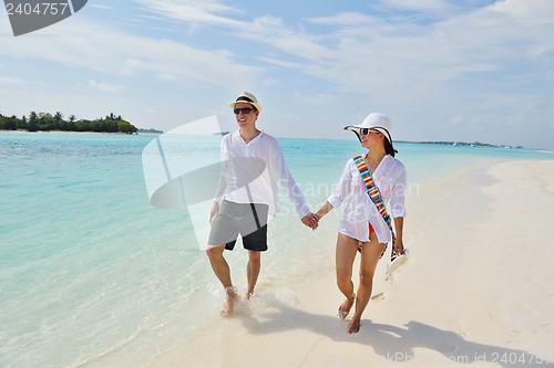Image of happy young couple have fun on beach