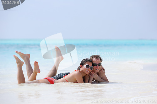 Image of happy young couple have fun on beach