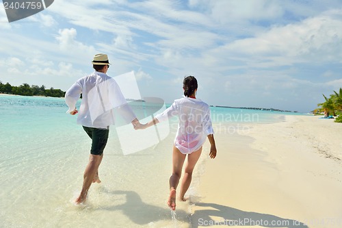 Image of happy young couple have fun on beach