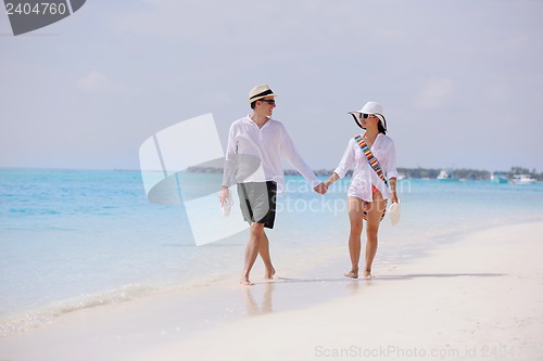Image of happy young couple have fun on beach