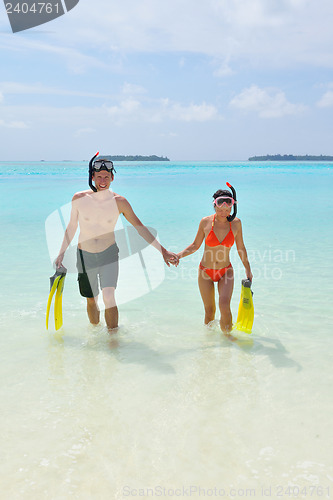 Image of happy young couple have fun on beach