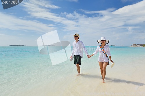 Image of happy young couple have fun on beach