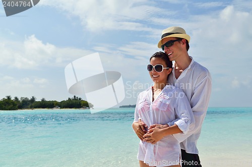 Image of happy young couple have fun on beach