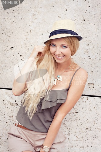 Image of happy young blonde woman with hat outdoor summertime