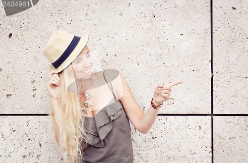 Image of happy young blonde woman with hat outdoor summertime