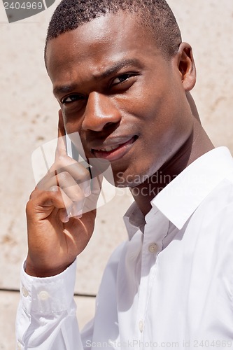 Image of young successfil african businessman with mobilephone 