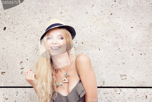 Image of happy young blonde woman with hat outdoor summertime