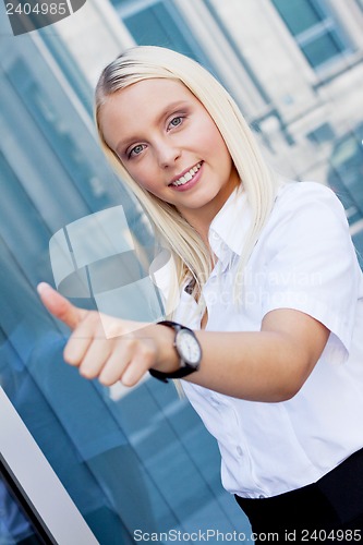 Image of attractive young successful smiling business woman standing outdoor 