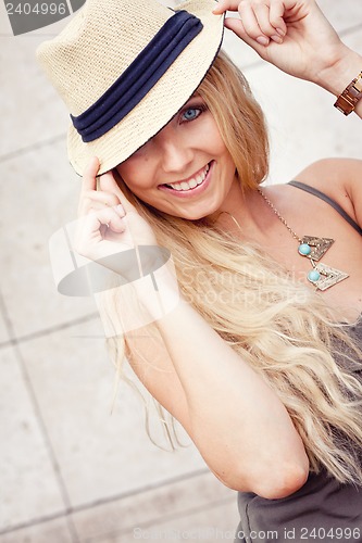 Image of happy young blonde woman with hat outdoor summertime