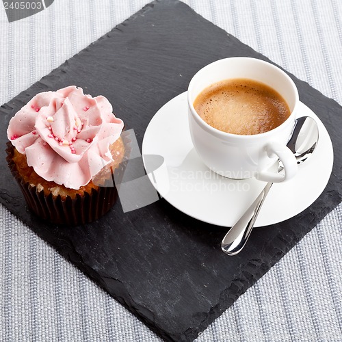 Image of tasty sweet cupcake and hot aromatic espresso coffee