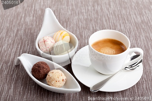 Image of sweet delicious truffle pralines chocolate and hot espresso coffee