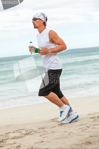 Image of man is jogging on the beach summertime sport fitness