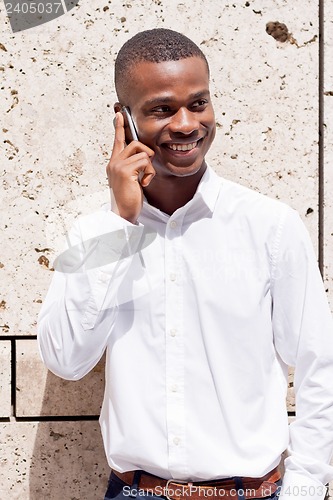 Image of young successfil african businessman with mobilephone 