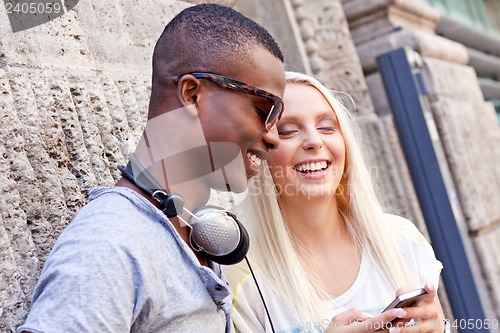 Image of happy young couple have fun in the city summertime 