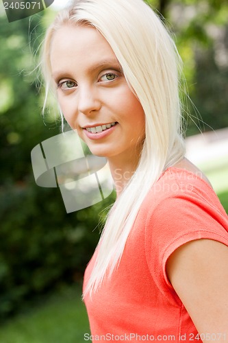 Image of beautiful young blonde girl lying in grass summertime