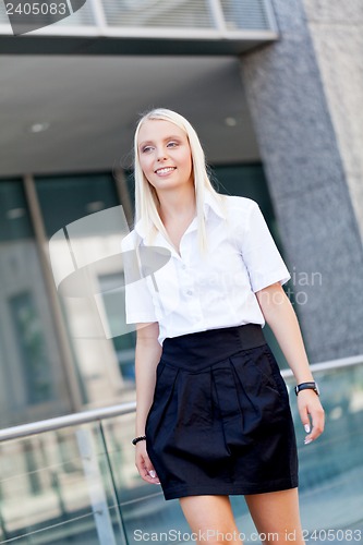 Image of attractive young successful smiling business woman standing outdoor 