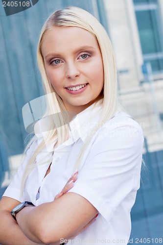 Image of attractive young successful smiling business woman standing outdoor 