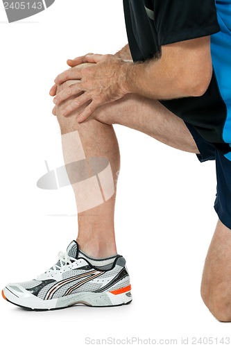 Image of adult attractive man in sportswear knee pain injury ache isolated