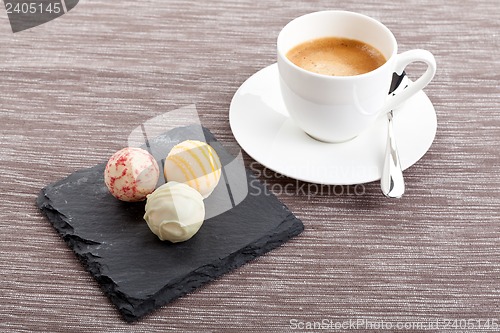 Image of sweet delicious truffle pralines chocolate and hot espresso coffee