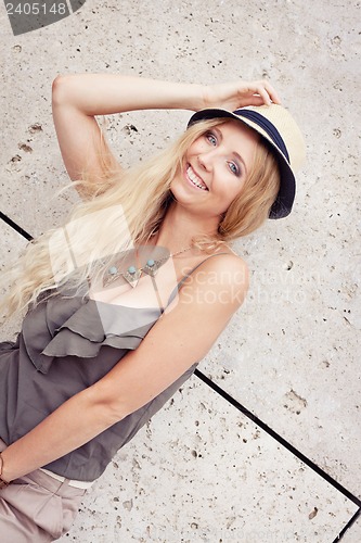 Image of happy young blonde woman with hat outdoor summertime