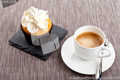 Image of tasty sweet cupcake and hot aromatic espresso coffee