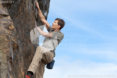 Image of man bouldering