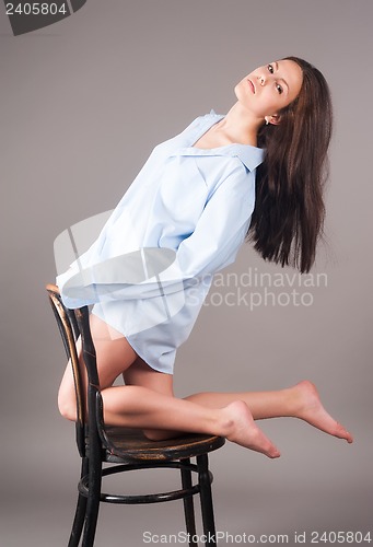 Image of Young elegant woman on chair