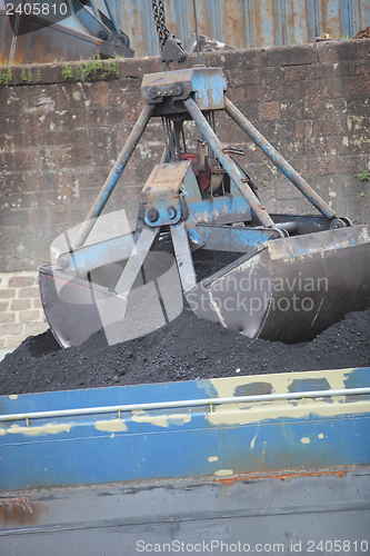 Image of Mechanical bucket picking up a load