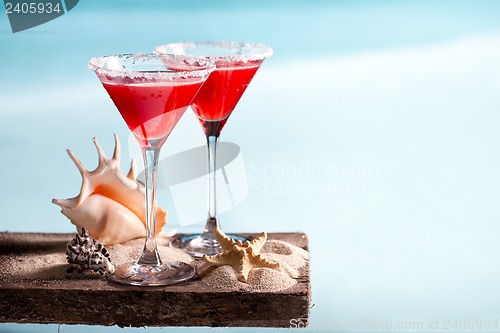 Image of red drink on beach