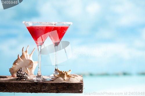 Image of red drink on beach