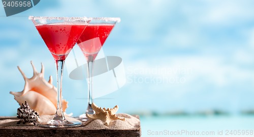 Image of red drink on beach