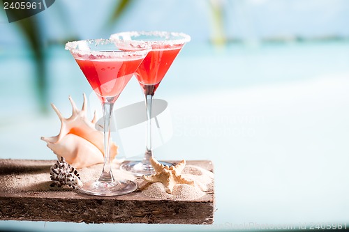 Image of red drink on beach