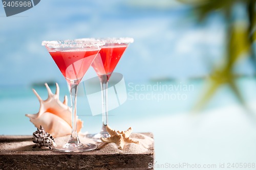 Image of red drink on beach