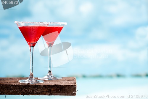 Image of red drink on beach